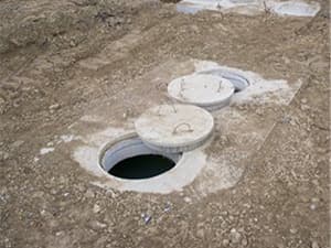 Open septic tank access ports prepared for pumping service Open septic tank access ports prepared for pumping service
