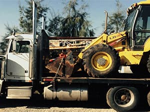 Heavy excavation and construction equipment ready for site work Heavy construction equipment being transported to a job site