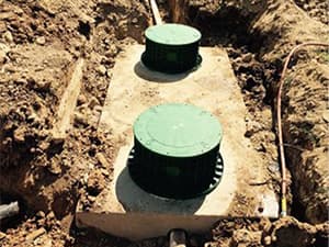Septic system access risers visible after installation and backfill Septic system access risers visible after installation and backfill