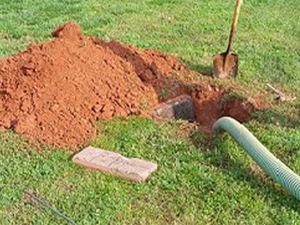 Septic tank access area opened for pumping and inspection Septic tank access area opened for pumping and inspection