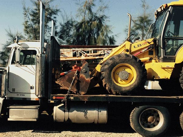 Heavy excavation and construction equipment ready for site work Heavy construction equipment being transported to a job site